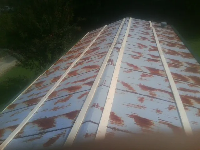 Rusted metal roof panels with new wood purlins before replacement — Storm Damage Roof Repair in Harleyville by Roofing Brothers